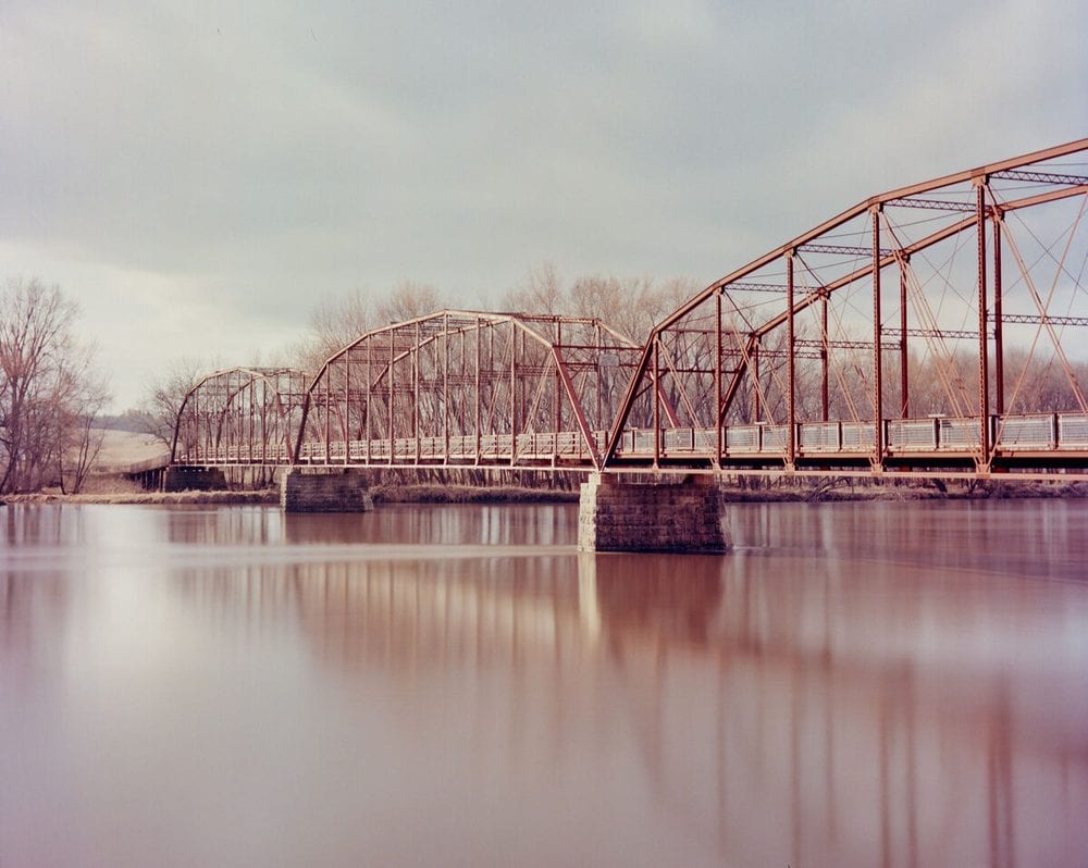 Truss bridge over a river in winter
