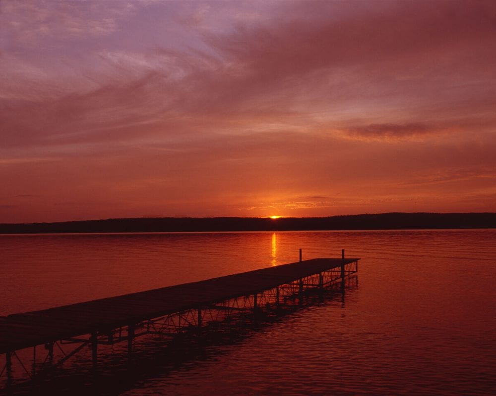 Dock at sunset over a still lake