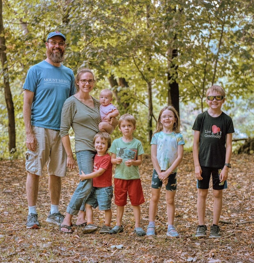 A family of seven in the autumn woods